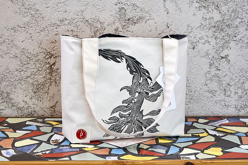 Wide natural canvas tote printed in black with a tall hand-carved botanical stem.